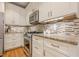 Well-equipped kitchen with granite countertops, stainless steel appliances, and ample storage space at 745 Amberton Close, Suwanee, GA 30024
