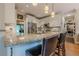 Modern kitchen with granite countertops, stainless steel appliances, and breakfast bar seating at 745 Amberton Close, Suwanee, GA 30024