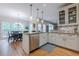 Bright kitchen with granite countertops, stainless steel appliances, and adjacent dining area at 745 Amberton Close, Suwanee, GA 30024