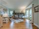 Bright living room featuring hardwood floors, modern furniture, and large windows that offer plenty of natural light at 745 Amberton Close, Suwanee, GA 30024