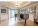 Elegant living room boasts a grand piano, bright bay window, and gallery wall at 745 Amberton Close, Suwanee, GA 30024