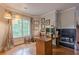 A functional home office includes desk space, a fireplace, and large windows that provide natural light at 745 Amberton Close, Suwanee, GA 30024