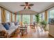 Bright sunroom with vaulted ceiling, large windows and nature views providing tranquil atmosphere at 745 Amberton Close, Suwanee, GA 30024