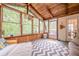 Inviting sunroom features wood accents, multiple windows, and access to the outdoor deck at 745 Amberton Close, Suwanee, GA 30024