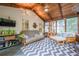 Bright sunroom with comfortable seating and large windows offering views of the surrounding landscape at 745 Amberton Close, Suwanee, GA 30024