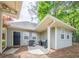 Back of the house, with a patio area and grill, and landscaped yard at 1655 Holly Lake Cir, Snellville, GA 30078