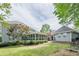 Spacious backyard featuring a charming screened-in porch, lush lawn, and well-maintained landscaping at 1655 Holly Lake Cir, Snellville, GA 30078