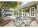Back patio with outdoor seating, featuring a door to the sunroom, and lush landscaping at 1655 Holly Lake Cir, Snellville, GA 30078
