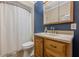 Bathroom featuring a vanity, sink, and a shower-tub with white shower curtain at 1655 Holly Lake Cir, Snellville, GA 30078