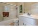 Clean bathroom featuring a shower-tub combo with sliding glass doors and a single sink vanity at 1655 Holly Lake Cir, Snellville, GA 30078