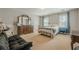 Spacious bedroom showcasing natural light, a large dresser, and a sitting area at 1655 Holly Lake Cir, Snellville, GA 30078