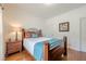 Cozy bedroom featuring hardwood floors, a comfortable bed, and soft, natural lighting at 1655 Holly Lake Cir, Snellville, GA 30078
