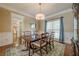 Formal dining room with hardwood floors, chandelier, and natural light at 1655 Holly Lake Cir, Snellville, GA 30078