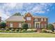 Beautiful two-story brick home with manicured front yard and mature landscaping at 1655 Holly Lake Cir, Snellville, GA 30078