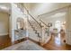 Inviting foyer featuring hardwood floors, staircase, and elegant decor at 1655 Holly Lake Cir, Snellville, GA 30078