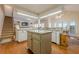 Open concept kitchen with an island, eat-in area, and plenty of natural light at 1655 Holly Lake Cir, Snellville, GA 30078