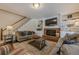 Inviting living room with a brick fireplace, built-in shelves, and a staircase leading to the upper level at 1655 Holly Lake Cir, Snellville, GA 30078