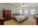 Spacious primary bedroom with neutral carpet, a ceiling fan and recessed ceiling lights, and bright windows at 1655 Holly Lake Cir, Snellville, GA 30078