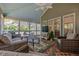 Bright sunroom with brick flooring, comfortable seating, ceiling fan, and views of the backyard at 1655 Holly Lake Cir, Snellville, GA 30078