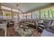 Bright sunroom with brick flooring, comfortable seating, ceiling fan, and views of the backyard at 1655 Holly Lake Cir, Snellville, GA 30078