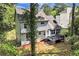 A wooden backyard deck with black railings leading to a chain link fence surrounding the yard at 2875 Riverbend Ct, Snellville, GA 30078