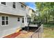 A wooden backyard deck with black railings leading to a chain link fence surrounding the yard at 2875 Riverbend Ct, Snellville, GA 30078