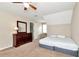 Bedroom with ceiling fan, natural light, and dark wood dresser at 2875 Riverbend Ct, Snellville, GA 30078