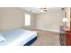 Neutral bedroom with ceiling fan, natural light, and dark wood dresser at 2875 Riverbend Ct, Snellville, GA 30078