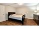 Cozy bedroom showcasing wood floors, a queen sized bed, and a dark dresser at 2875 Riverbend Ct, Snellville, GA 30078