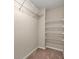 Organized walk-in closet featuring shelving to maximize storage space, and neutral colored carpet at 2875 Riverbend Ct, Snellville, GA 30078