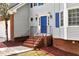 Inviting front entrance with brick steps and a bright blue door at 2875 Riverbend Ct, Snellville, GA 30078