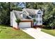 Charming two-story home with a brick-accented garage and blue shutters at 2875 Riverbend Ct, Snellville, GA 30078