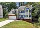 Charming two-story home with a brick-accented garage and blue shutters at 2875 Riverbend Ct, Snellville, GA 30078