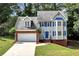 Charming two-story home with blue shutters and a well-manicured lawn and attached two car garage at 2875 Riverbend Ct, Snellville, GA 30078