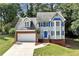 Charming two-story home with blue shutters and a well-manicured lawn and attached two car garage at 2875 Riverbend Ct, Snellville, GA 30078