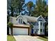 Charming two-story home with a brick-accented garage and blue shutters at 2875 Riverbend Ct, Snellville, GA 30078