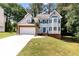 Charming two-story home with a well-manicured lawn, brick accents, and a two car garage at 2875 Riverbend Ct, Snellville, GA 30078