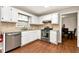 Updated kitchen with stainless steel appliances, white cabinetry, and breakfast bar at 2875 Riverbend Ct, Snellville, GA 30078