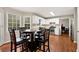 Eat-in kitchen features white cabinets, stainless steel appliances, hardwood floors, and lots of natural light at 2875 Riverbend Ct, Snellville, GA 30078