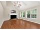 Bright living room with vaulted ceiling, fireplace, hardwood floors, and natural light from large windows at 2875 Riverbend Ct, Snellville, GA 30078