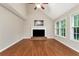 Bright living room with vaulted ceiling, fireplace, hardwood floors, and natural light from large windows at 2875 Riverbend Ct, Snellville, GA 30078