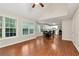 Bright living room with hardwood floors, many windows, and an open floorplan leading to kitchen at 2875 Riverbend Ct, Snellville, GA 30078