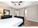 Comfortable main bedroom with neutral tones leading to the ensuite bathroom with dual vanity at 2875 Riverbend Ct, Snellville, GA 30078