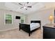 Relaxing main bedroom with a ceiling fan, two windows, and an elegant dresser at 2875 Riverbend Ct, Snellville, GA 30078