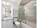 Bathroom showcasing granite countertops, tub-shower combo with sliding glass door, and vanity at 3053 Lawson Dr, Marietta, GA 30064
