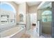 Primary bathroom features a soaking tub, tile shower, and windows with shutters at 3053 Lawson Dr, Marietta, GA 30064