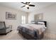 Bedroom featuring a large bed with stylish linens, chair and wooden floors at 3053 Lawson Dr, Marietta, GA 30064