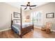 Comfortable bedroom featuring a four-poster bed, ceiling fan, and bright window with wooden floors at 3053 Lawson Dr, Marietta, GA 30064