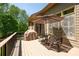 Outdoor deck with an umbrella, dining furniture and wooded views at 3053 Lawson Dr, Marietta, GA 30064