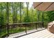 Deck with views of the wooded backyard, equipped with outdoor furniture and umbrella at 3053 Lawson Dr, Marietta, GA 30064